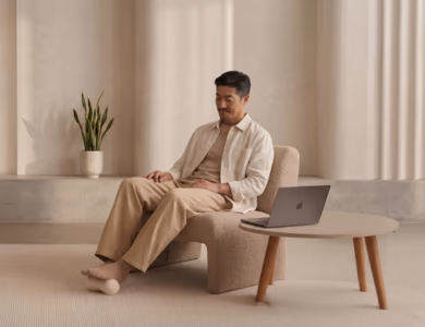 Employee taking a short BetterMe movement break in a quiet office lounge with a laptop on a low table