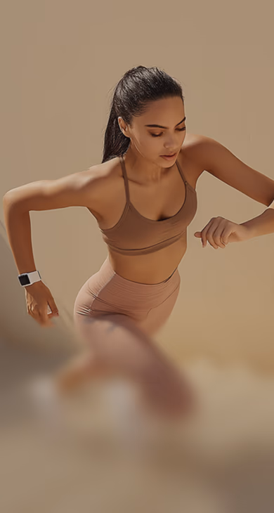 Employee running up the stairs wearing a fitness tracker for a BetterMe Business corporate step challenge